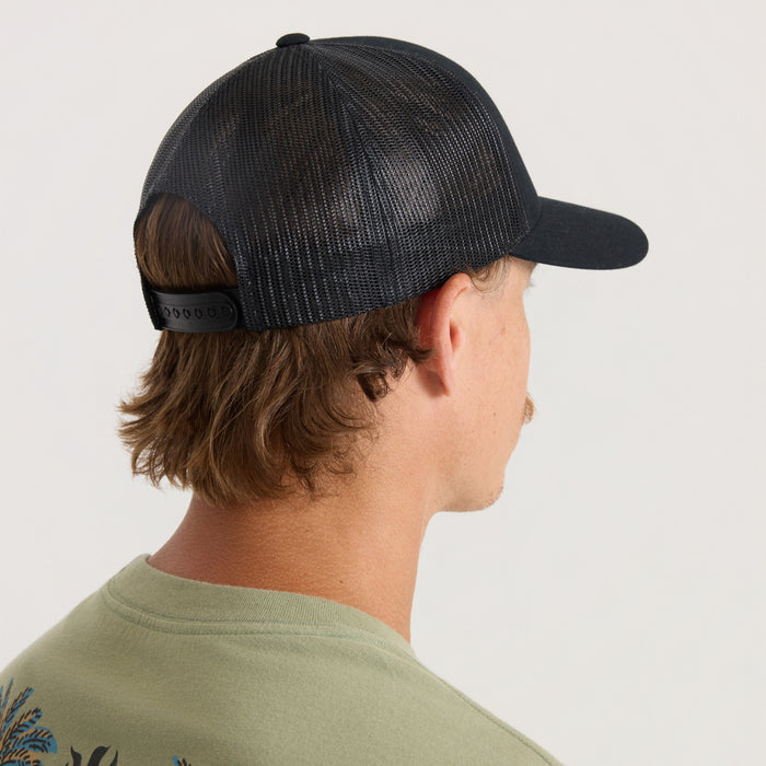 Black mesh trucker snapback hat worn by man in profile view, showing snapback closure and ventilated panels