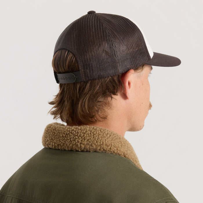Dark brown mesh trucker snapback hat with adjustable strap worn on model shown from back view