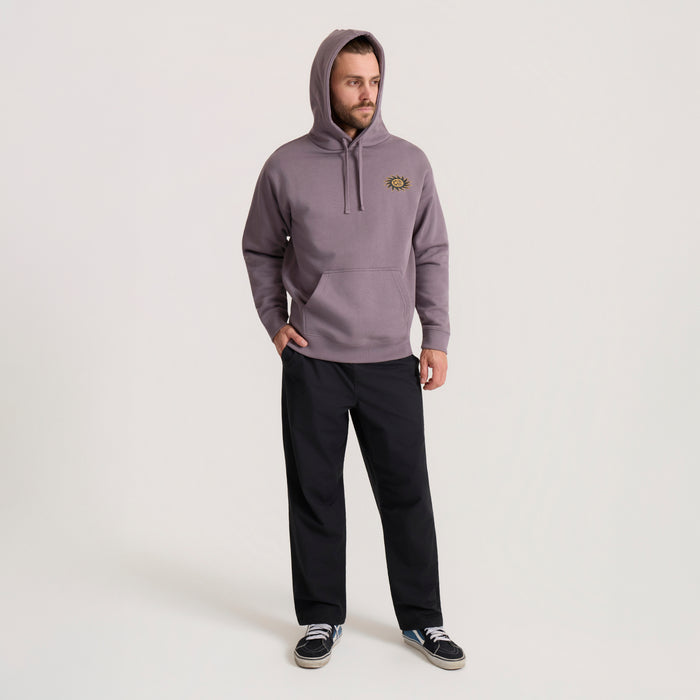 Mauve Sunbeam Hoodie with small sun emblem worn with black pants and sneakers on model
