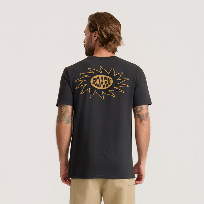 Black Sunbeam Premium Tee with gold sun graphic and ROARK text on back, worn by man with tattoos