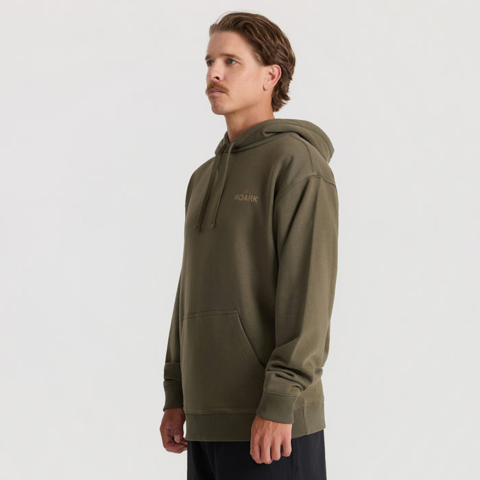 Man wearing military green Roark Tri Camp hoodie with small chest logo and kangaroo pocket, side profile view