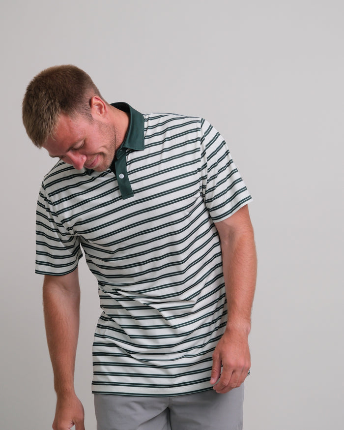Man wearing a cream and green striped short sleeve polo shirt