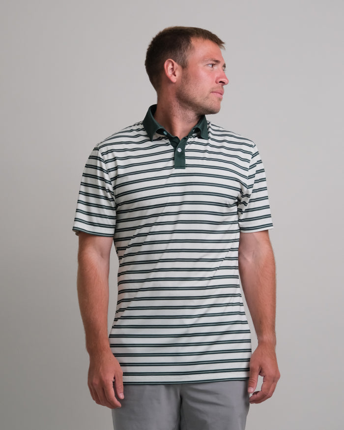 Man wearing a cream and green striped short sleeve polo shirt