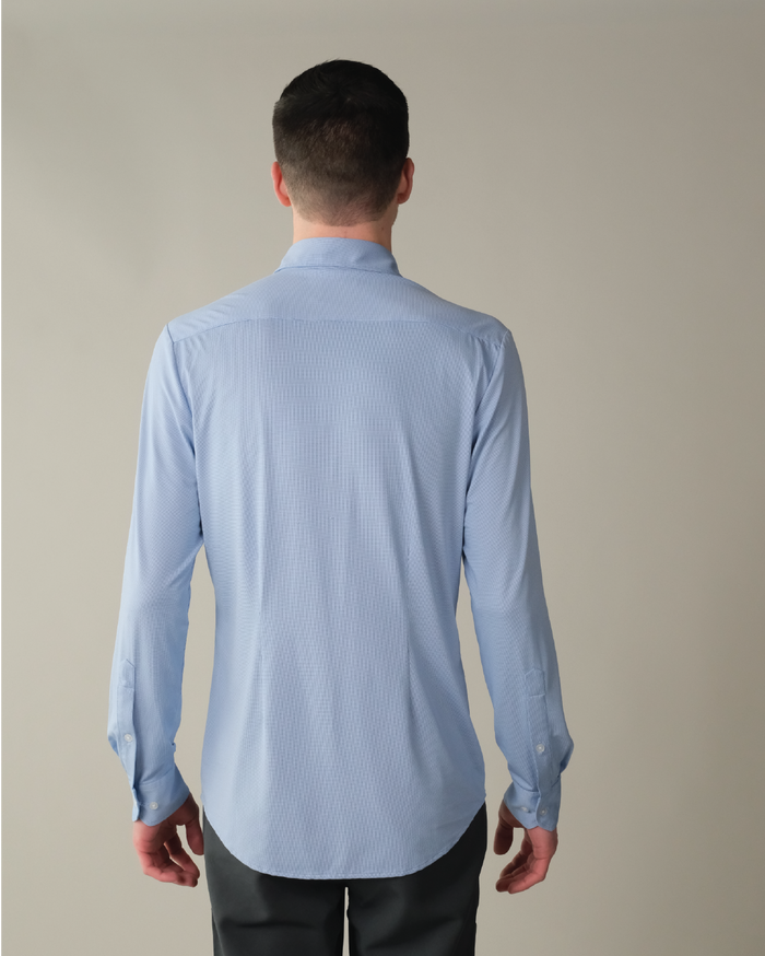 Man wearing a french blue shirt and dark pants