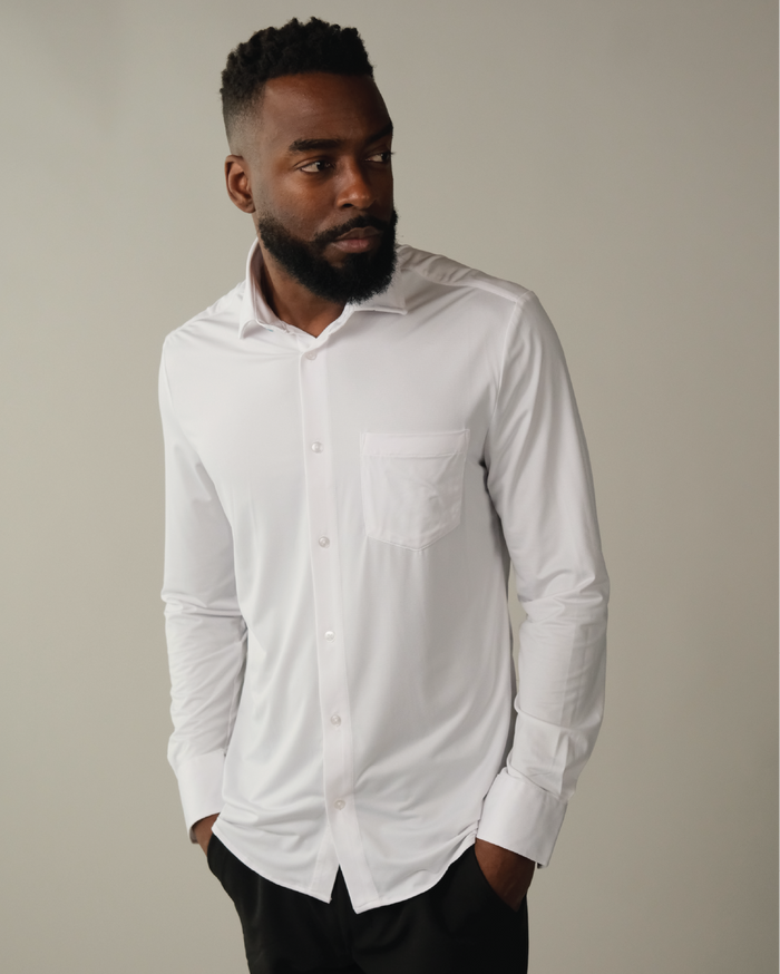 Man wearing a white dress shirt against a neutral background