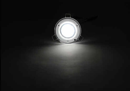 Valterra 12V RV LED Interior Downlight Illuminated Against Dark Background - Bright Output | United RV Parts