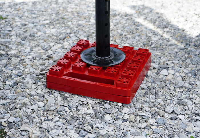 Red Plastic StayPut Stackers Leveling RV Stabilizer Jack - In Use | United RV Parts