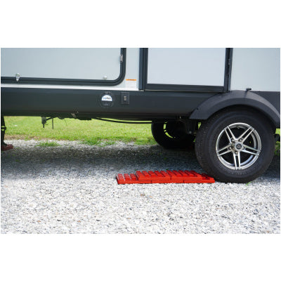 Red Plastic StayPut Stackers Under RV Trailer Wheel - Application View | United RV Parts