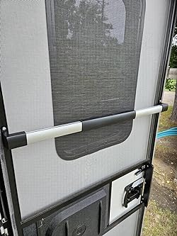 Valterra RV Screen Door Crossbar Installed on RV Screen Door - In-Use Context View | United RV Parts
