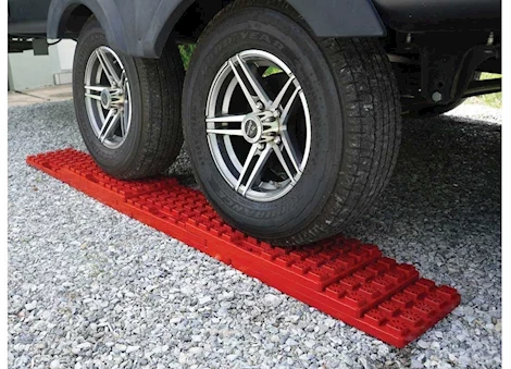Red Valterra StayPut RV Leveling Stackers Under Trailer Tire - In-Use Scene | United RV Parts