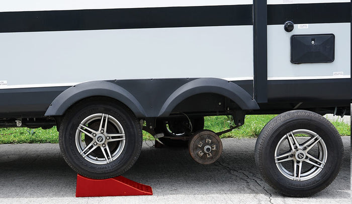 Red Valterra StayPut Trailer Jack A10-0905 under dual axle trailer with tire removed - Side View | United RV Parts