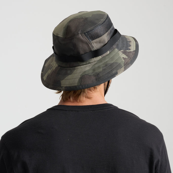 Camouflage pattern in a natural setting, reflecting Roark’s spirit of adventure and exploration.