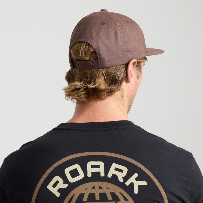 Man with a beard wearing a Roark cap, embodying an adventurous and outdoor style.