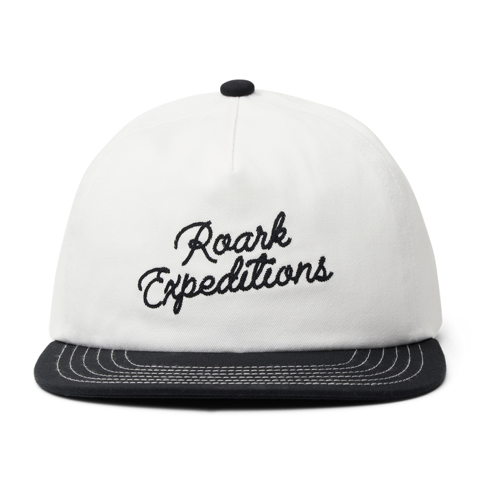 Stylish white Roark trucker hat, ideal for outdoor adventures and travel, displayed on a neutral background.