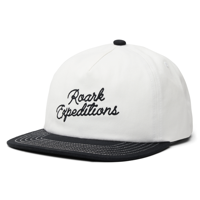 Stylish white trucker hat by Roark, perfect for outdoor adventures and travel