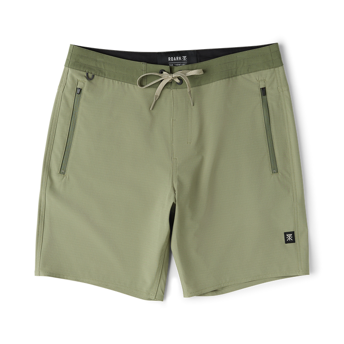 Dusty sage Venture Hybrid Trunk with drawstring waist, zippered side pockets, and black inner waistband displayed flat lay