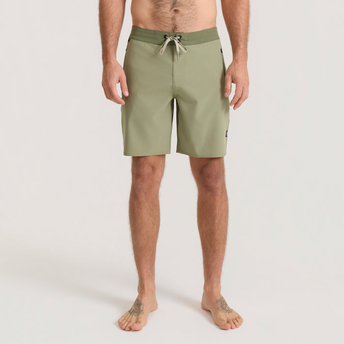 Sage green Venture Hybrid Trunk with drawstring waistband on shirtless male model standing barefoot against neutral background