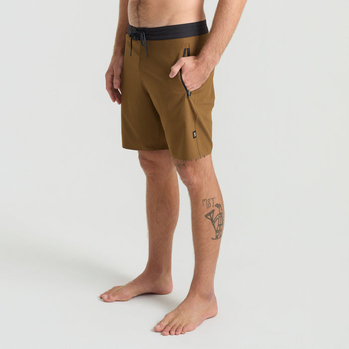 Stylish Roark boardshorts on a sunny beach, ideal for adventure and travel