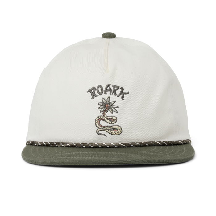 Adventurous traveler in Roark gear navigating a rugged landscape at sunrise