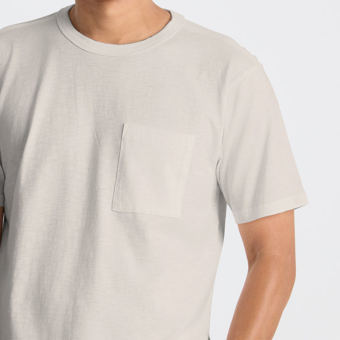 Close-up view of a durable Roark active shirt featuring utility pockets and breathable fabric, designed for adventure and travel