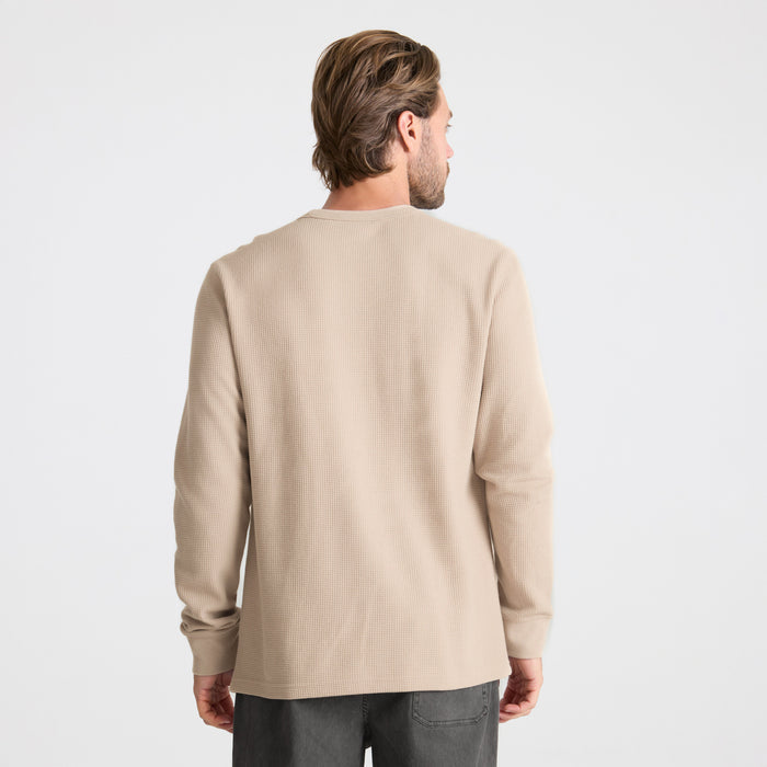 Model wearing a long-sleeved Roark T-shirt in an adventurous outdoor setting
