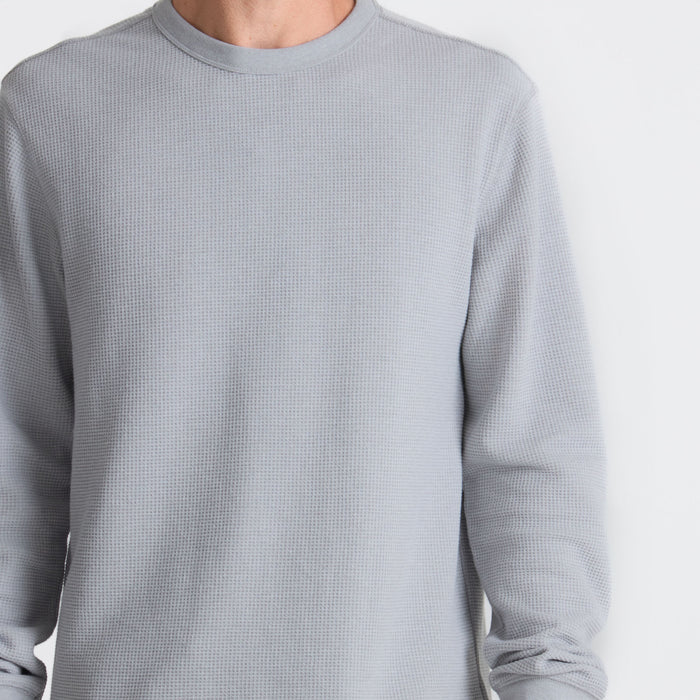 Grey long-sleeved active shirt made of wool, perfect for outdoor adventures and travel, by Roark.