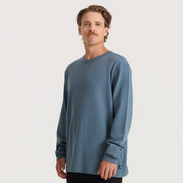 Man wearing slate blue thermal long sleeve tee with textured fabric, standing against neutral background in front view