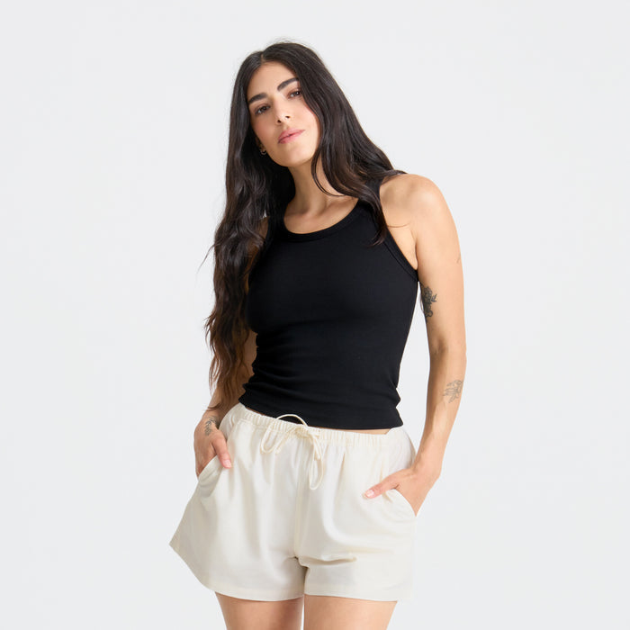 Close-up of a person wearing a sleeveless black shirt, emphasizing the details suitable for outdoor adventures.