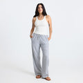 Close-up of grey active pants and foot, ideal for travel and adventure, showcasing the comfortable and durable design.
