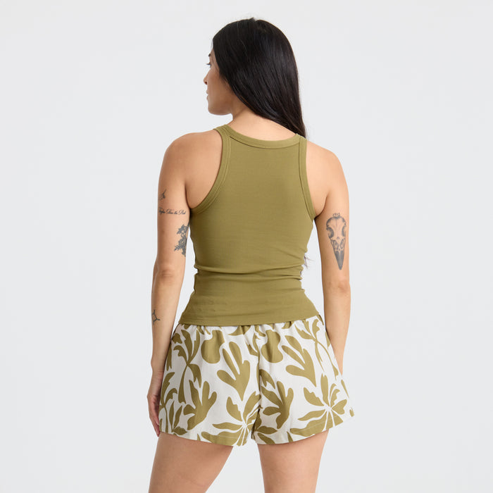 Model showcasing active wear, featuring sleeveless shirt and shorts, ideal for outdoor and travel adventures by Roark.