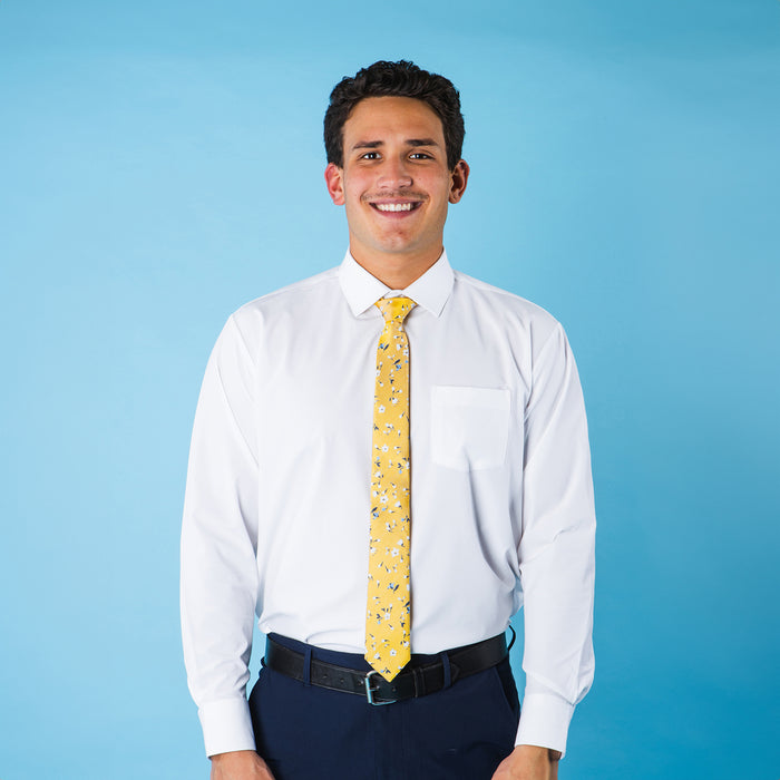 Yellow tie with white and blue floral design on a white dress shirt